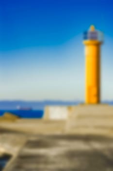 Yellow lighthouse - soft lens bokeh image. Defocused background