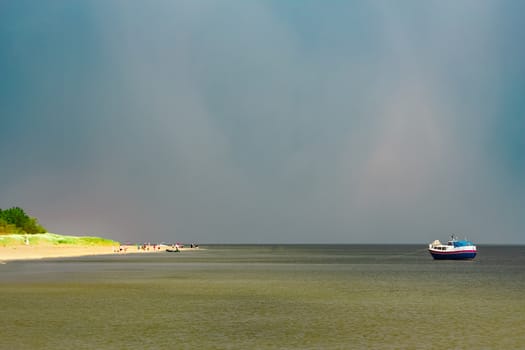 Small blue passenger ship moored at Baltic sea bay