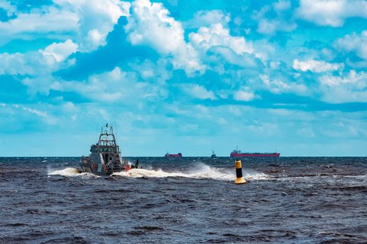 Grey military ship sailing at Baltic sea. Border guard service