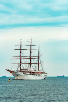 Big white sailing ship with three mast moving to the Riga port