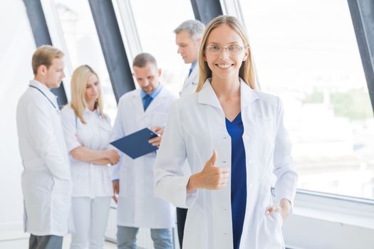 Young female doctor and medical team in hospital