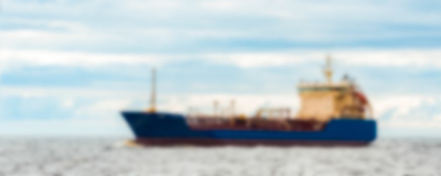 Blue cargo ship - soft lens bokeh image. Defocused background