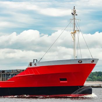 Red new cargo ship moving abroad. Product export in Europe