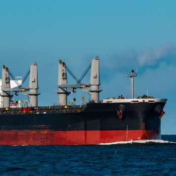 Black bulker ship. Logistics and merchandise transportations