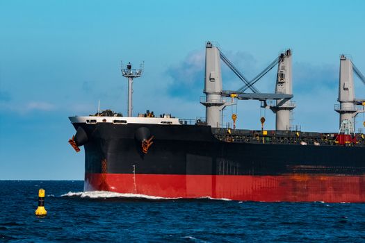 Black bulker ship. Logistics and merchandise transportations