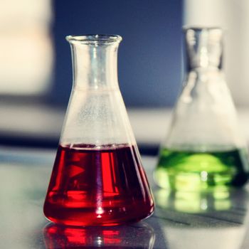 small flask with red liquid in the laboratory. a photo