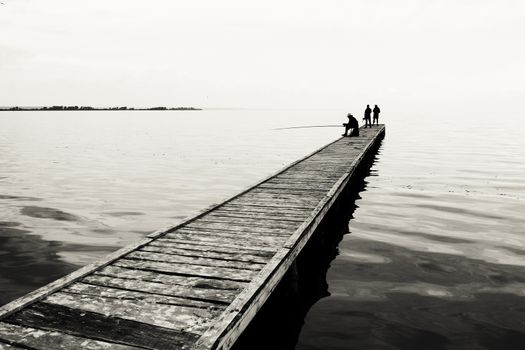 old bridge on the river or lake. photo. black and white