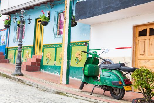 Green motorcycle at the colorful town of Guatape, Antioquia – Colombia.