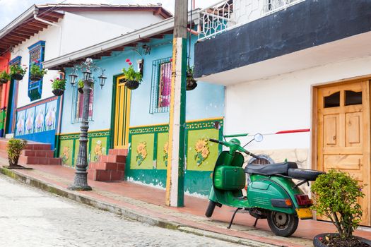 Green motorcycle at the colorful town of Guatape, Antioquia – Colombia.