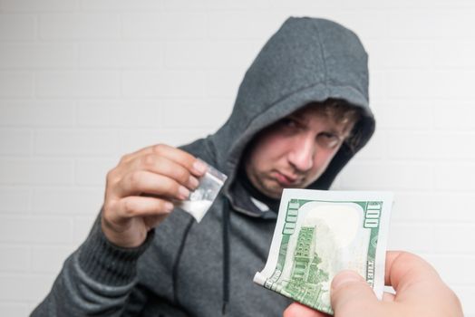 purchase drug dose from a drug dealer on the street, hand in close-up