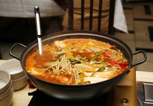 Delightful healthy Asian kitchen - magnificent and nutritious Korean soup with noodles and seafoods