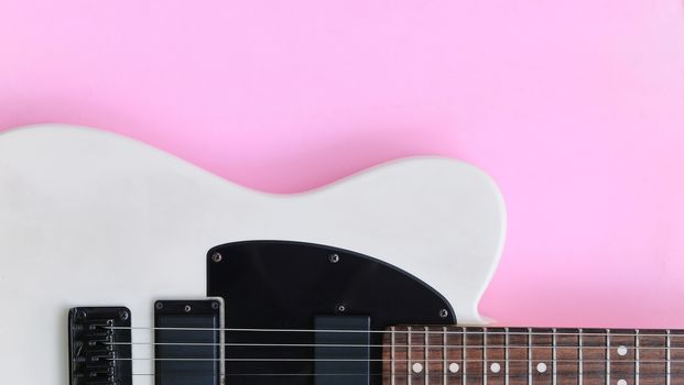Detail of Electric Guitar on a pink background.
