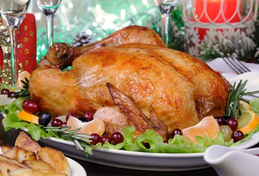 Delicate baked chicken   with an appetizing crust with a citrus garnish on the Christmas table