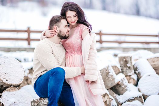 a bride in a fur coat with a fiance among the Carpathian mountains