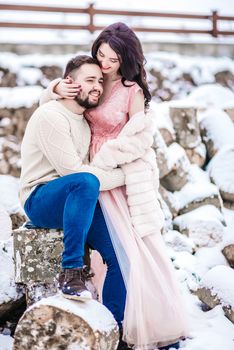 a bride in a fur coat with a fiance among the Carpathian mountains