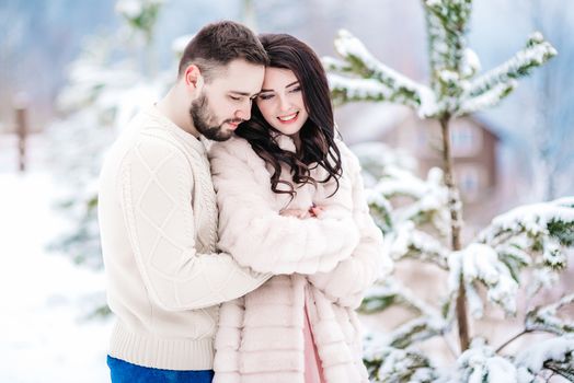 a bride in a fur coat with a fiance among the Carpathian mountains