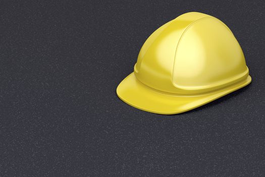Yellow safety helmet on the asphalt