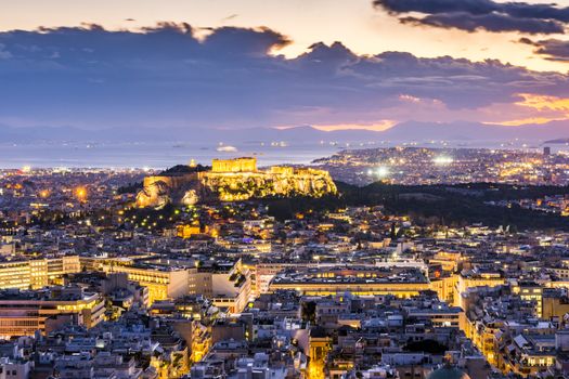 night shot of acropolis with part of athens city