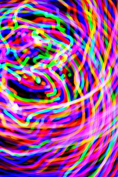 Abstract multi-color light trails shot with long exposure at night. Light painting.