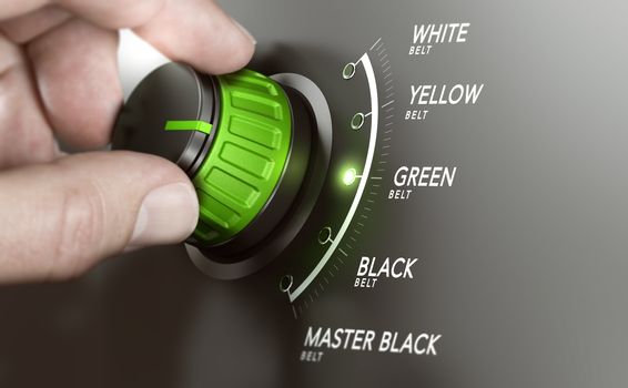 Hand turning a knob over grey background and selecting the green belt level. Lean management training concept. Composite image between a hand photography and a 3D background.