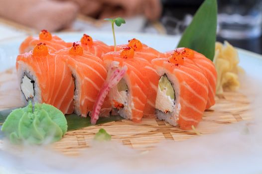 Fresh sushi on a platter is cooled with ice.