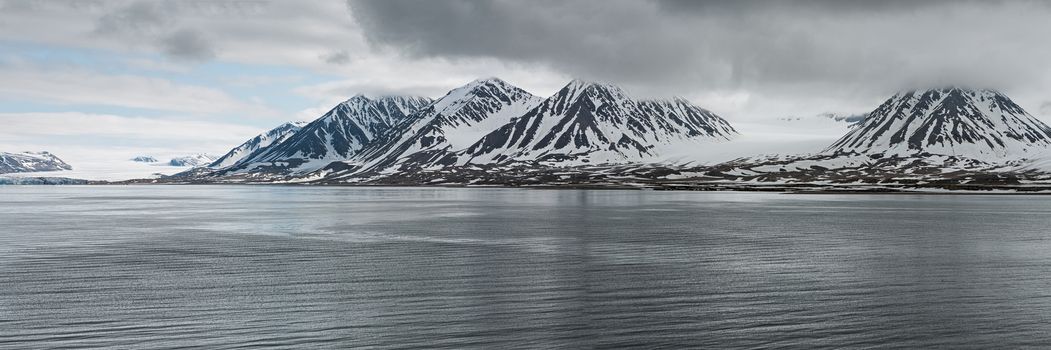 Panoramic mountains in Svalbard islands in a cloudy day, Norway