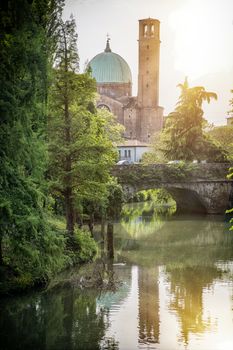 View to park and bridge over river on background of historic building in Treviso, Italy.