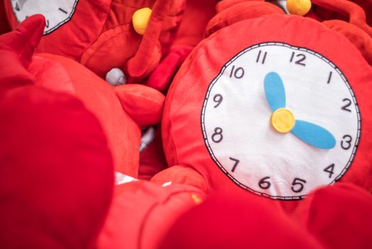 red soft toy clock in the box in the toy store