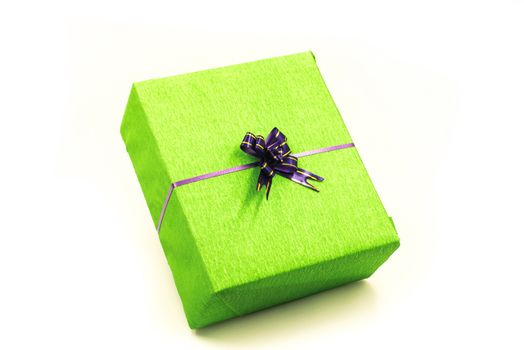 bright green hand made gift box with nice wrapping and purple bow. Happy holidays.