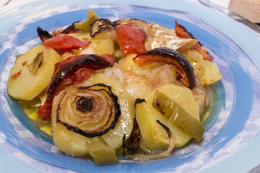 Traditional portuguese meal done in the oven, codfish with potatoes in olive oil.