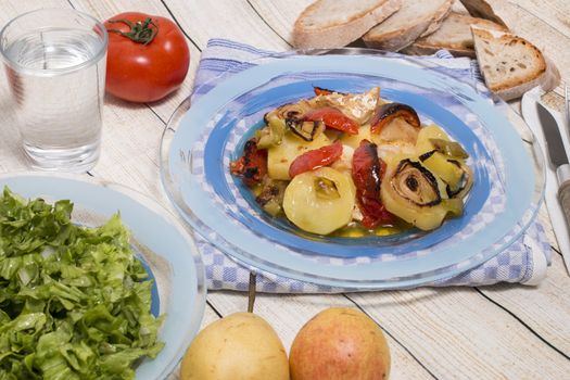 Traditional portuguese meal done in the oven, codfish with potatoes in olive oil.