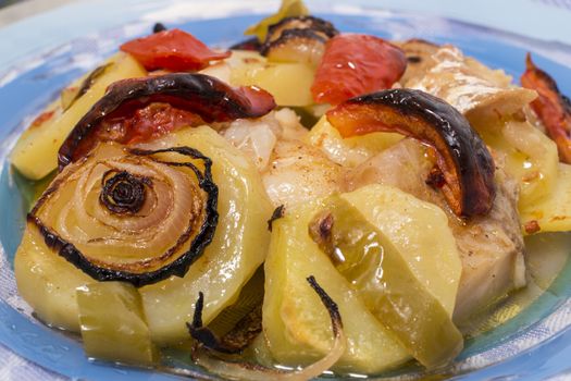 Traditional portuguese meal done in the oven, codfish with potatoes in olive oil.