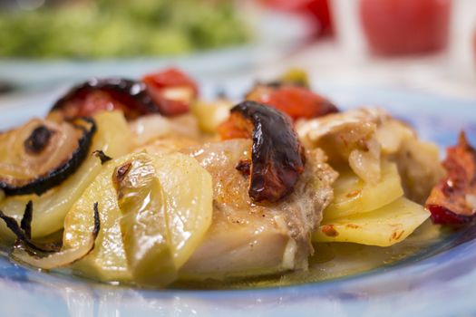 Traditional portuguese meal done in the oven, codfish with potatoes in olive oil.