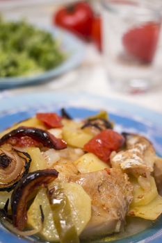 Traditional portuguese meal done in the oven, codfish with potatoes in olive oil.
