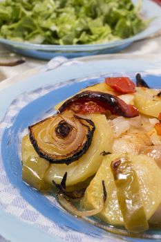 Traditional portuguese meal done in the oven, codfish with potatoes in olive oil.
