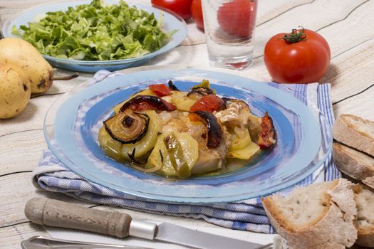 Traditional portuguese meal done in the oven, codfish with potatoes in olive oil.