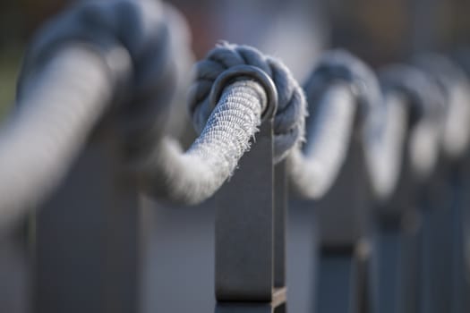 Close up focus view of rope on a wooden pathway.