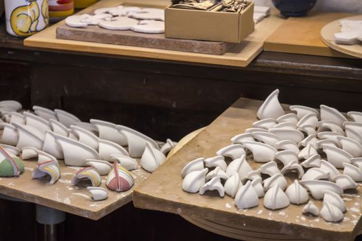 Close up view of souvenir ceramic workshop, with unfinished pieces.
