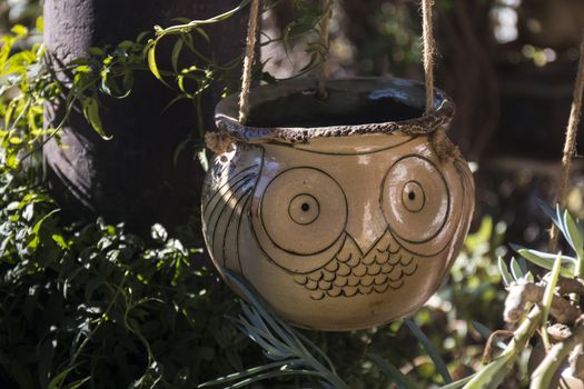 Curious ceramic flower pots on a garden.