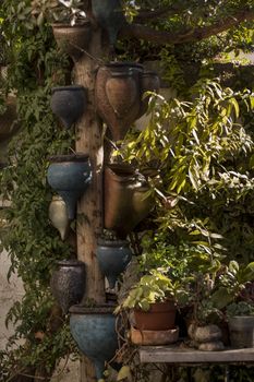 Curious ceramic flower pots on a garden.