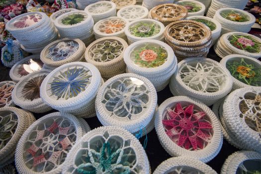 Varied mix of colorful knitted souvenirs depicting Portuguese designs.