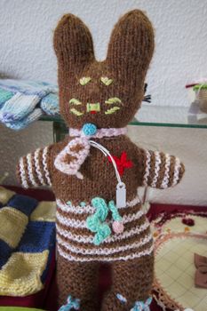 Close up view of a Brown Stuffed bunny hand knitted.