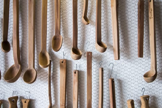 Close up view of a group of homemade wooden spoons for use in the kitchen.