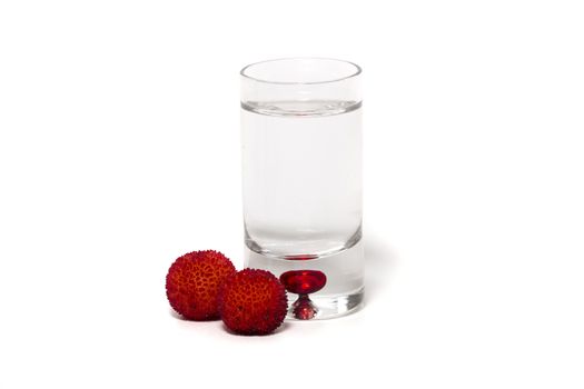 Close up view of strawberry tree (Arbutus Unedo) fruit with aguardiente isolated in white background.