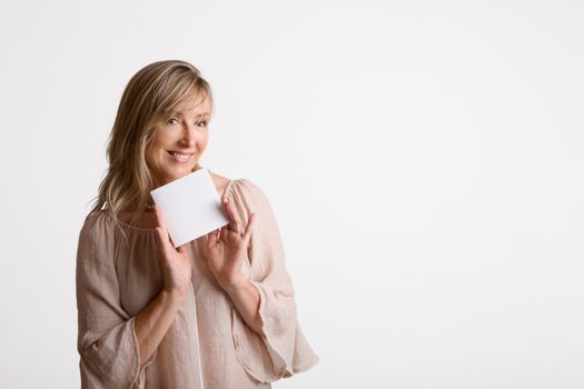 Woman holding a blank card, note, brochure, message