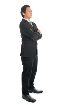 Full body arm crossed young Southeast Asian businessman standing isolated on white background. 