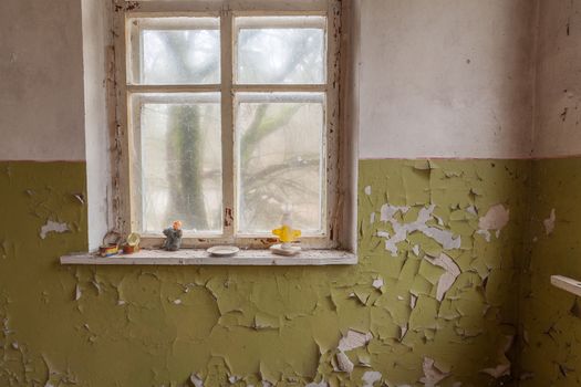 Window in abandoned kindergarten with old cracky walls. Chernobyl, Ukraine