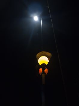 light pole orange lamp at night turned on street urban; essex; england; uk