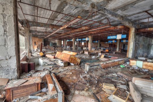 Abandoned and ruined supermarket in overgrown ghost city Pripyat near Chernobyl nuclear power plant in Ukraine.