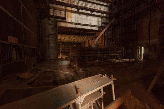 Room in abandoned theater in overgrown ghost city Pripyat near Chernobyl nuclear power plant in Ukraine.